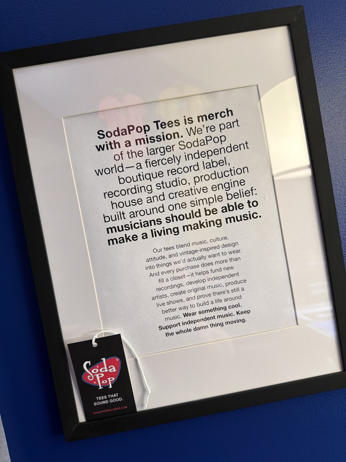 Framed SodaPop Tees statement describing its support for independent music
