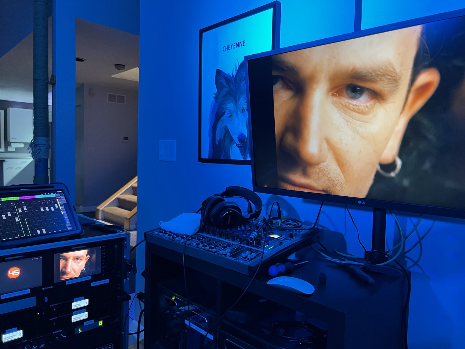 Video screens, audio controls, and equipment under blue lighting at SodaPop House